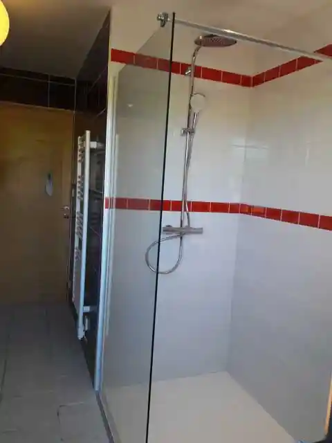 Radiateur et douche dans salle de bain rénovée